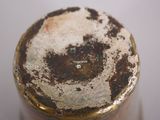 a close up of a bottle with dirt on it