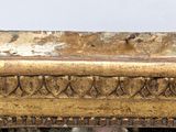 a close up of a gold frame with a bird on it