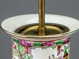 a vase that has a gold handle and a handle on it