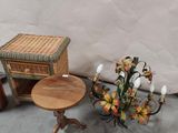a small table with a basket on it next to a small table with a vase on it