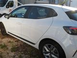a white car that is parked next to a white van