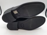 a pair of black shoes sitting on top of each other
