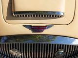 a close up view of a car ' s grill and badge