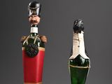 two bottles of wine with a soldier figurine on top of them