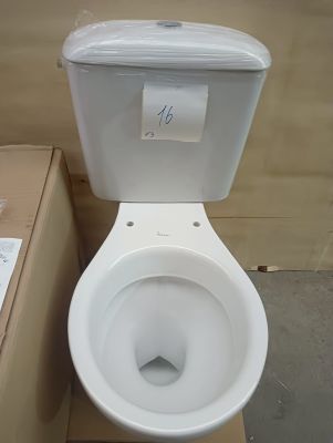 a white toilet with a paper label on the tank
