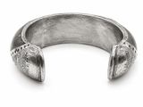 silver cuff bracelet with engraved design on it on a white background