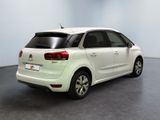 a white car that is parked in a room