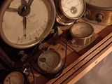many different types of clocks displayed on a shelf