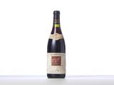 a bottle of wine sitting on top of a white table