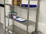a metal shelving with a bin and a trash can