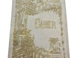 an old book with a golden cover sitting on top of a table