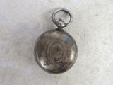 an old silver pocket watch with a chain hanging from it ' s side