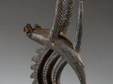 an image of a statue of a bird on a stand