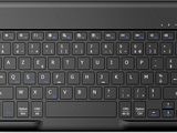 a black keyboard with blue keys on a white surface