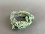 a close up of a green bracelet on a table