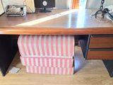 a desk with a chair and a computer on top of it