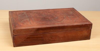 a small wooden box on a table with a lid