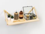 a wooden shelf with a mirror, a brush, and other items on it