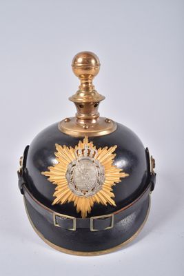 a black and gold bell with a sunflower on it