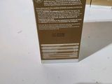 the back of a box of a bottle of liquid sitting on a table