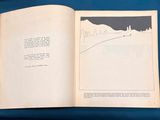 an open book with a picture of a person walking on a hill