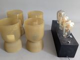 four glasses and a lamp on a table
