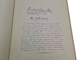 an open book with a handwritten poem on it sitting on a table