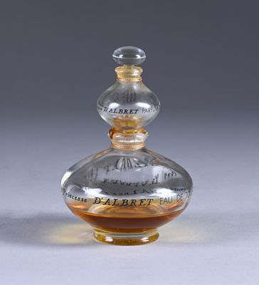 a clear glass bottle with a brown liquid inside of it