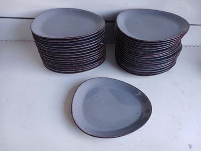 a lot of plates sitting on a counter top