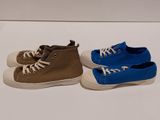 two pairs of blue and brown sneakers on a white surface