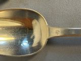a silver spoon with a handle on a table