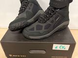 a pair of black water shoes on top of a box