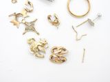 a lot of gold jewelry on a white surface