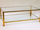 brass and glass coffee table with a glass top