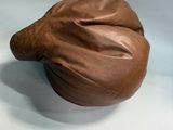 a brown object sitting on a white surface next to a brown object