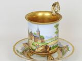 a cup and saucer with a picture of a castle on it