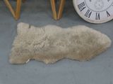 a sheepskin rug on the floor next to a clock