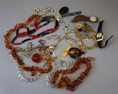 many different necklaces and bracelets laid out on a table