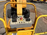 a yellow machine that is sitting in the middle of a parking lot