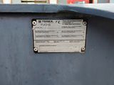 a metal sign on the side of a blue container