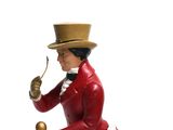 a figurine of a man in a top hat holding a pipe