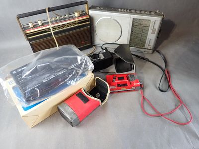 a radio, cassette player, cd player, and other items on a table