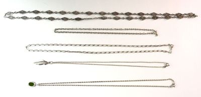 a lot of different chains on a white surface