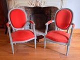 two chairs that are sitting in front of a fire place