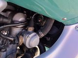 a close up of the engine of a green motorcycle