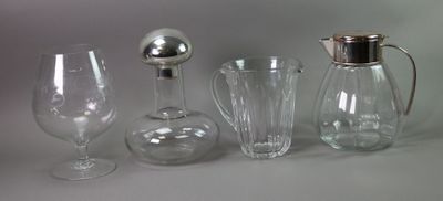 four different types of glassware sitting on a table
