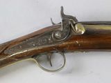 a close up of a gun on a white surface