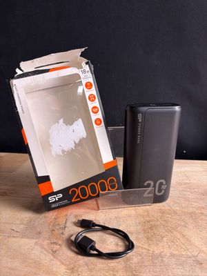 an image of a box with a charger sitting on top of a wooden table