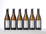 six bottles of wine are lined up on a table
