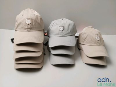 several hats are lined up on a table in a row